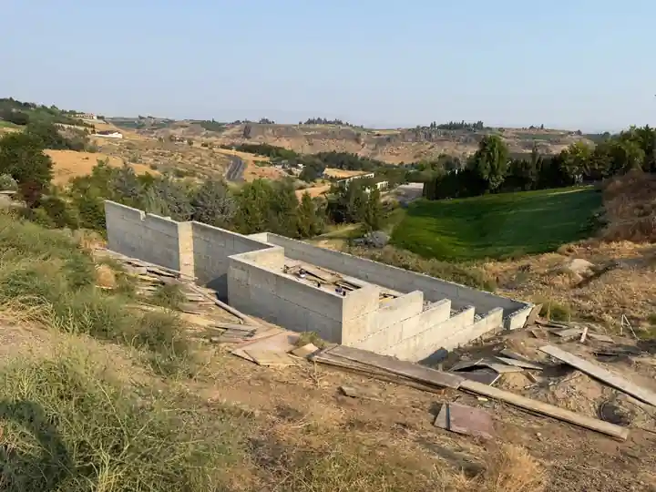 Stepped concrete block wall built into a ravine slope