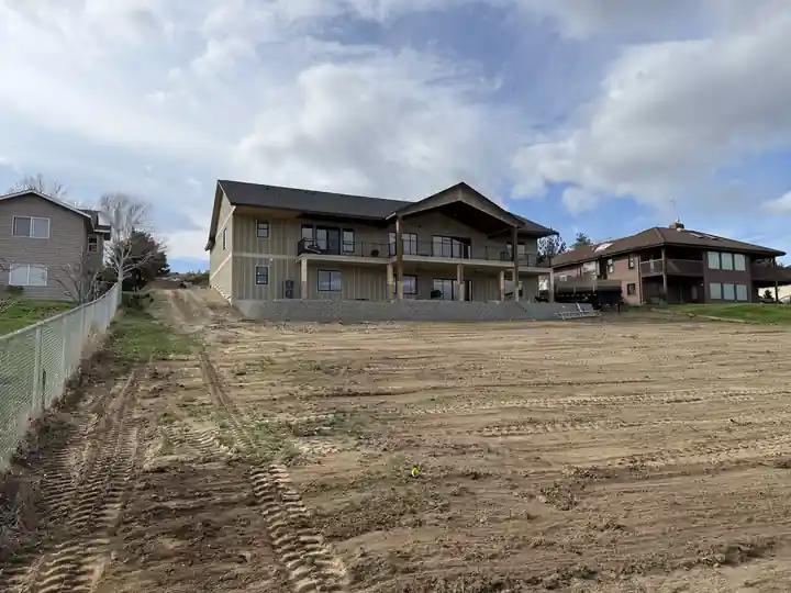 Graded lot next to a finished two-storey home